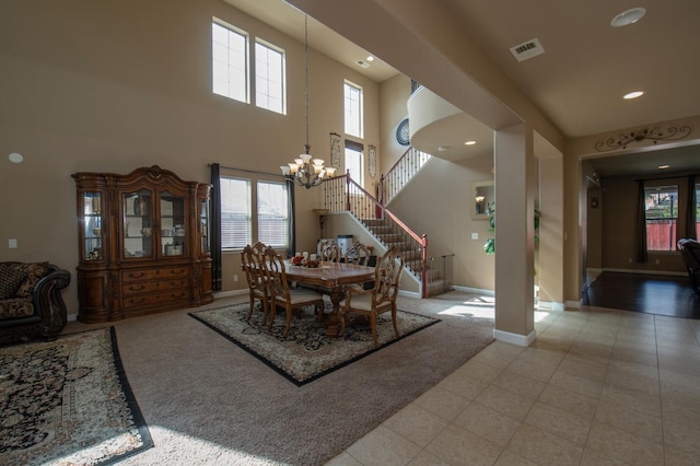 dining area with a chandelier, visible vents, stairway, and baseboards