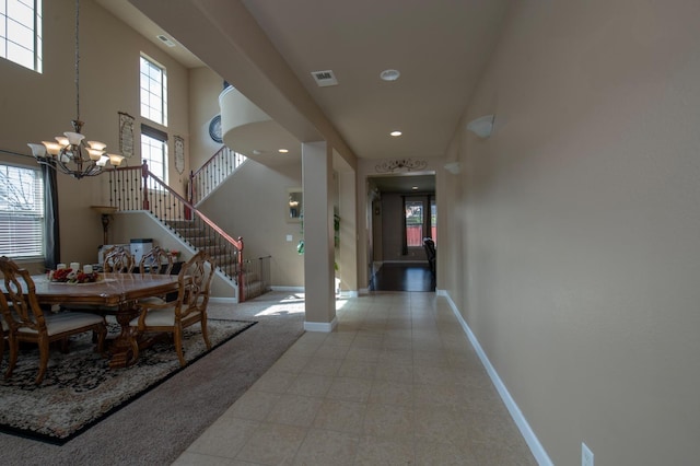 dining space featuring a healthy amount of sunlight, stairway, visible vents, and baseboards