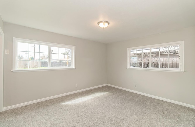 unfurnished room featuring baseboards and carpet flooring