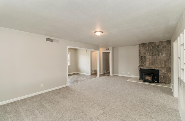 unfurnished living room featuring carpet floors, baseboards, and visible vents