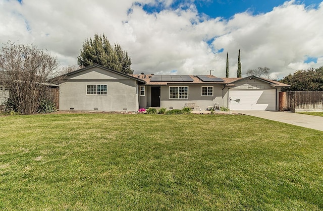 ranch-style home featuring a garage, solar panels, crawl space, fence, and a front yard