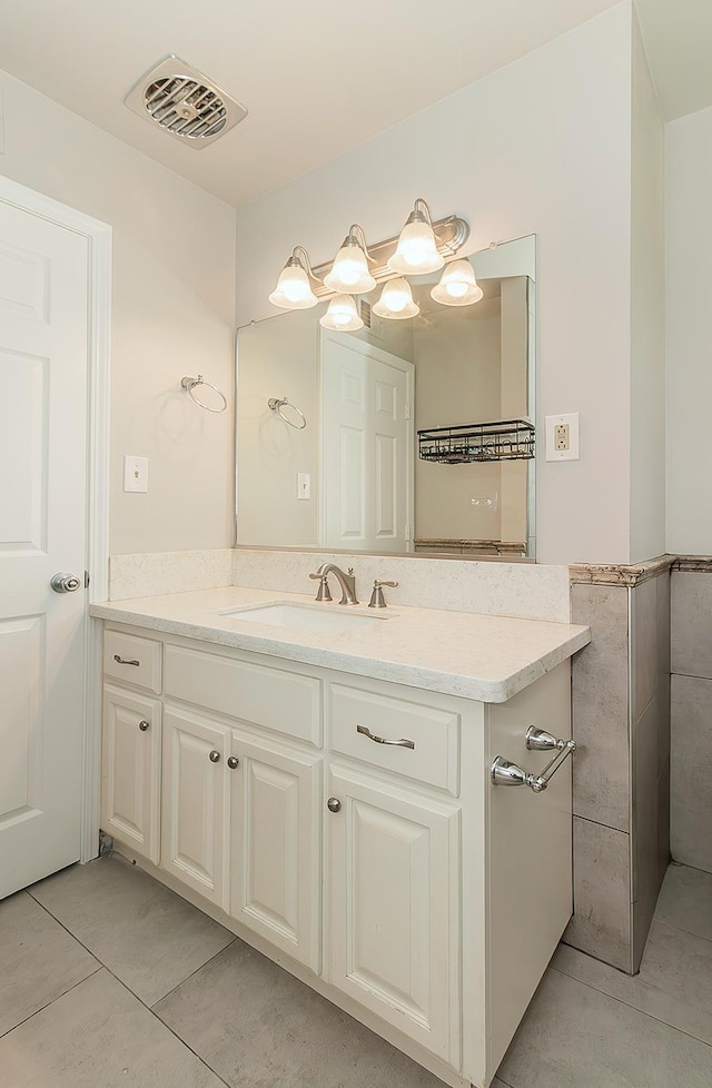 bathroom with tile walls, visible vents, vanity, and tile patterned floors