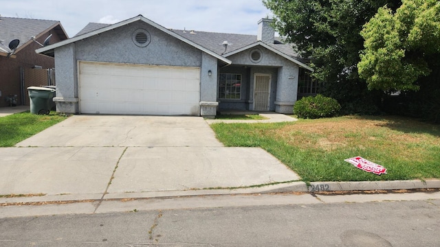 ranch-style home with a garage, a chimney, driveway, a front yard, and stucco siding