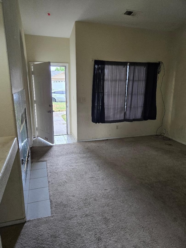 carpeted foyer featuring a fireplace