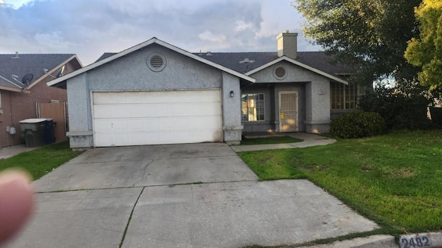 ranch-style house featuring a chimney, stucco siding, concrete driveway, an attached garage, and a front yard