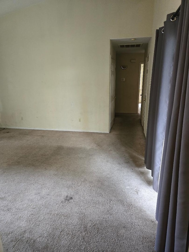 unfurnished room with carpet flooring and visible vents
