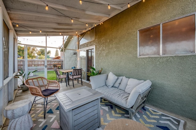 sunroom with lofted ceiling with beams and track lighting