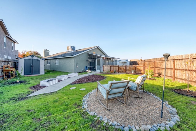 back of house with an outdoor fire pit, a fenced backyard, a storage shed, an outdoor structure, and a lawn