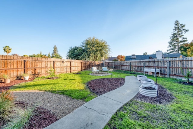 view of yard with an outdoor fire pit and a fenced backyard