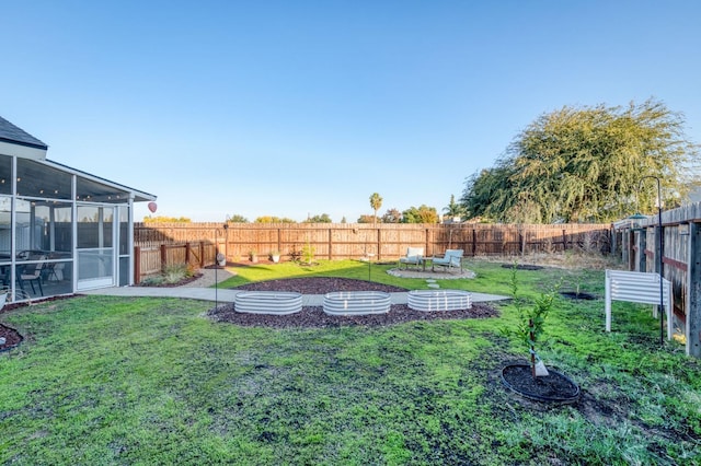 view of yard with a sunroom and a fenced backyard