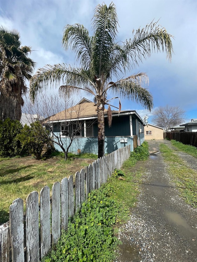 view of side of property featuring a fenced front yard