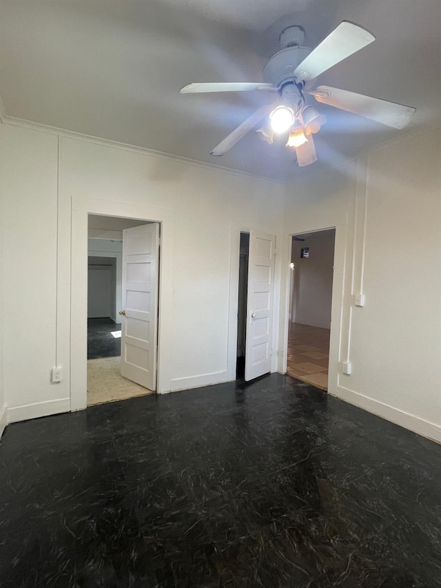 unfurnished bedroom featuring crown molding, baseboards, and ceiling fan