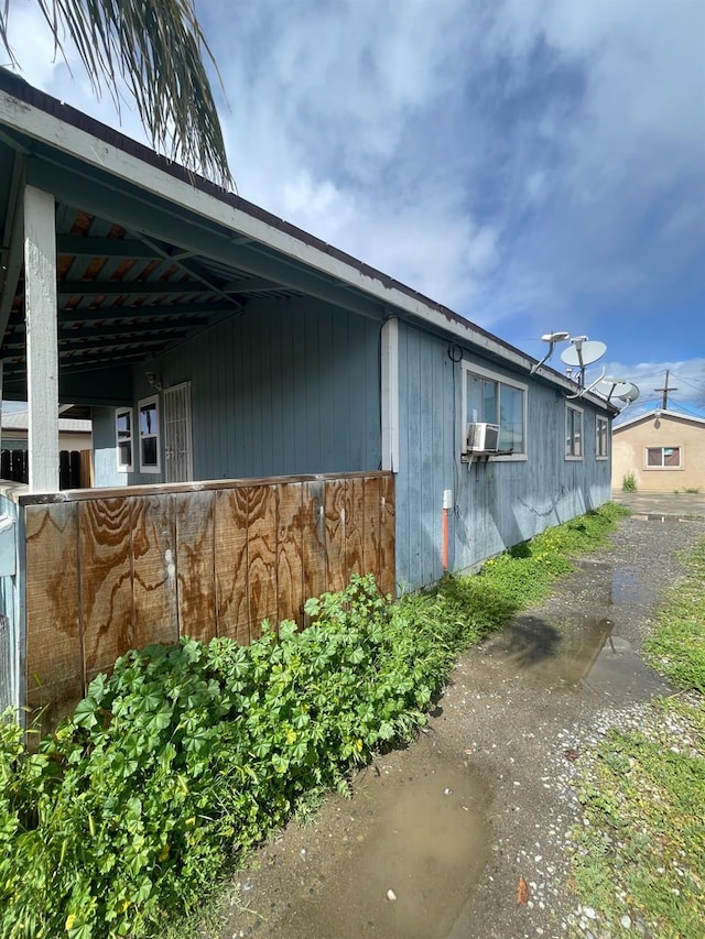 view of home's exterior featuring an exterior structure, cooling unit, and an outbuilding