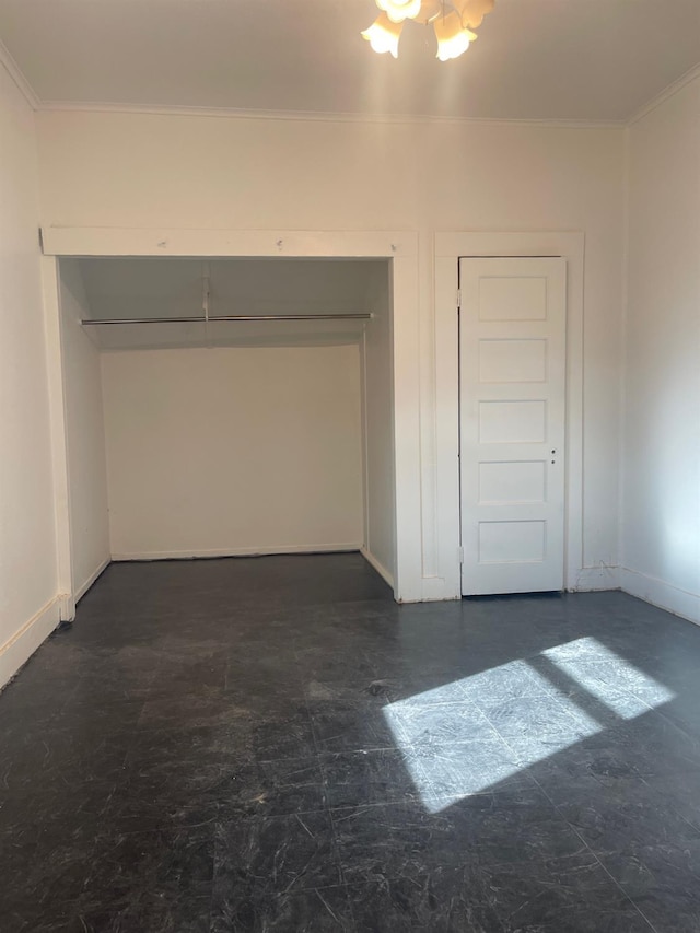 interior space with ornamental molding and baseboards