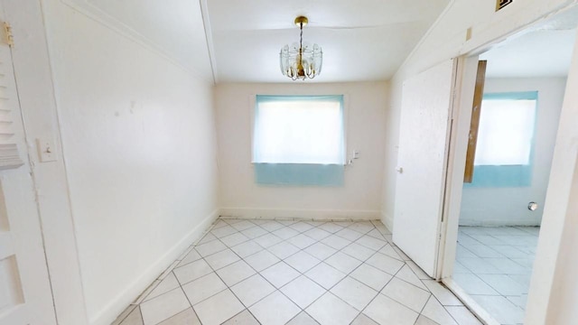 683 E Polk St, Coalinga, CA 93210 - spare room featuring baseboards, an inviting chandelier, and plenty of natural light