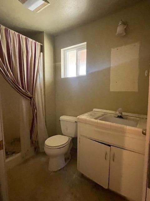 683 E Polk St, Coalinga, CA 93210 - full bath with vanity, a stall shower, and toilet