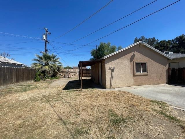 683 E Polk St, Coalinga, CA 93210 - view of home's exterior with fence and stucco siding