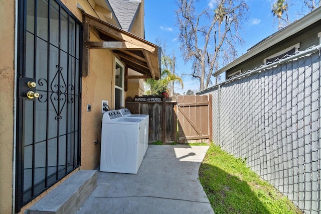 exterior space with fence and washer / clothes dryer