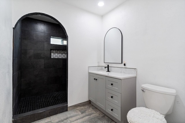 bathroom with vanity, toilet, and walk in shower