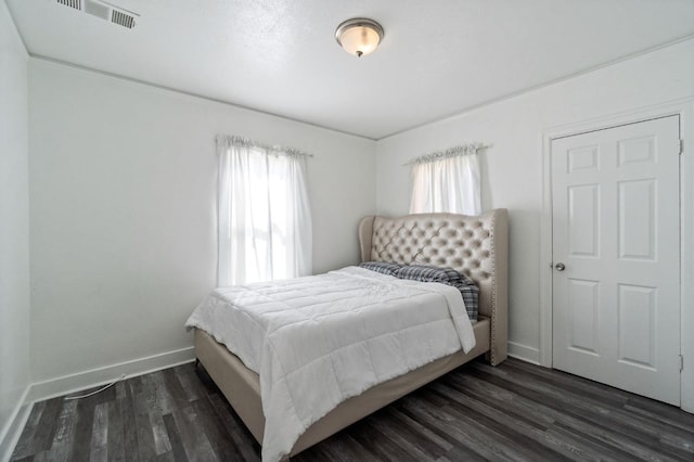 bedroom featuring visible vents, dark wood finished floors, and baseboards