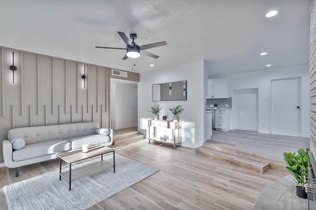 living area featuring a ceiling fan, recessed lighting, visible vents, and light wood-style flooring