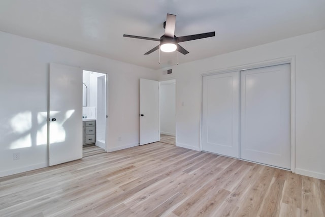 unfurnished bedroom with light wood-style floors, baseboards, visible vents, and a closet