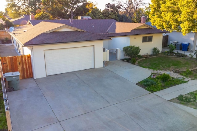 ranch-style house featuring driveway, a gate, fence, and stucco siding