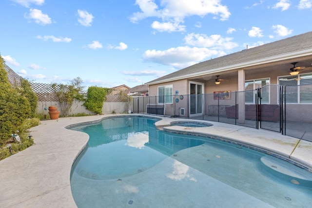 view of swimming pool with a fenced backyard, a pool with connected hot tub, a ceiling fan, and a patio