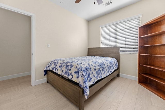 bedroom with visible vents, ceiling fan, baseboards, and wood finished floors