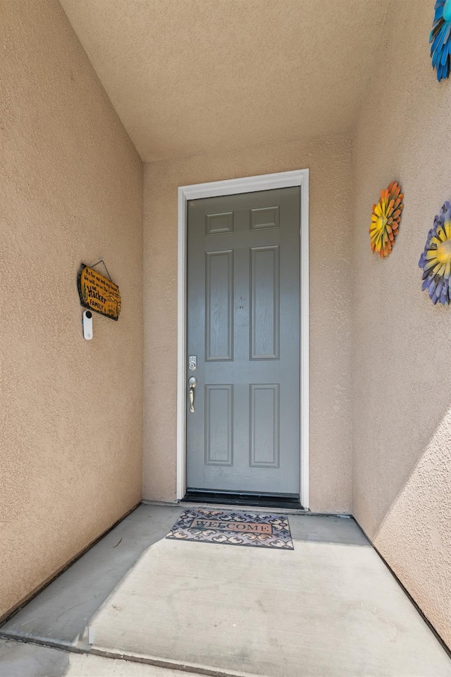 property entrance featuring stucco siding