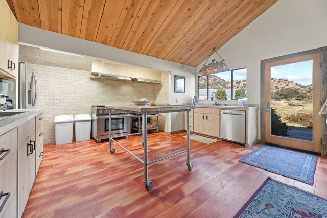 kitchen with wood ceiling, appliances with stainless steel finishes, vaulted ceiling, light countertops, and light wood-type flooring