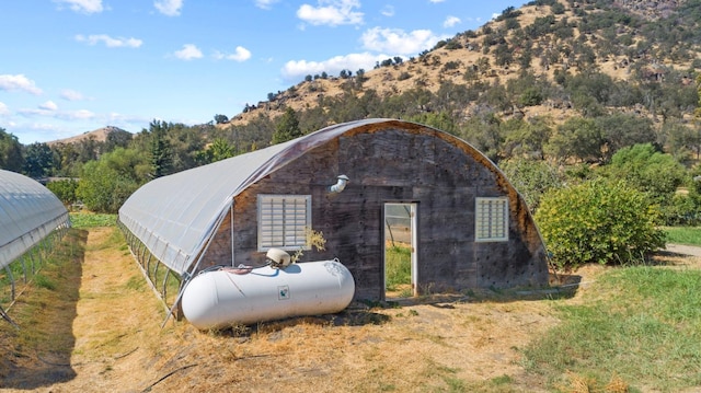 view of outdoor structure with a mountain view and an outbuilding