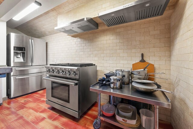 kitchen featuring wall chimney exhaust hood, brick wall, extractor fan, stainless steel appliances, and light wood-style floors