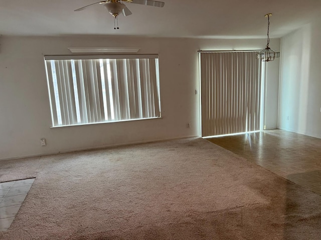 unfurnished room with carpet and a ceiling fan