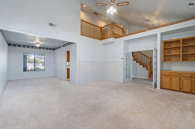 unfurnished living room with light carpet, ceiling fan, and visible vents