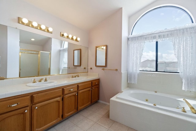 bathroom with a sink, a shower stall, a tub with jets, and double vanity