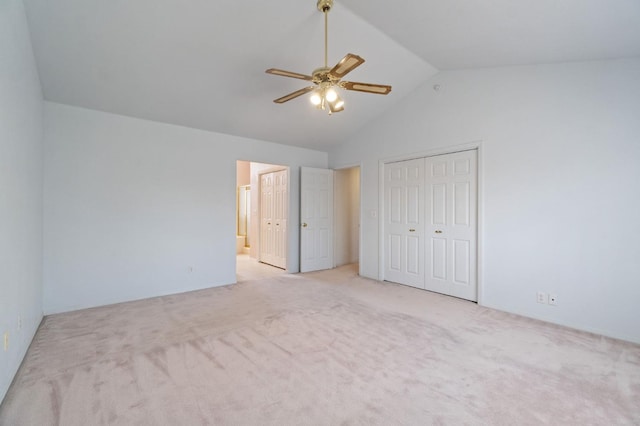 unfurnished bedroom with carpet, connected bathroom, vaulted ceiling, and a closet