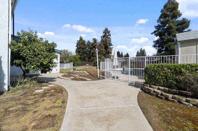 view of gate with a patio area and fence