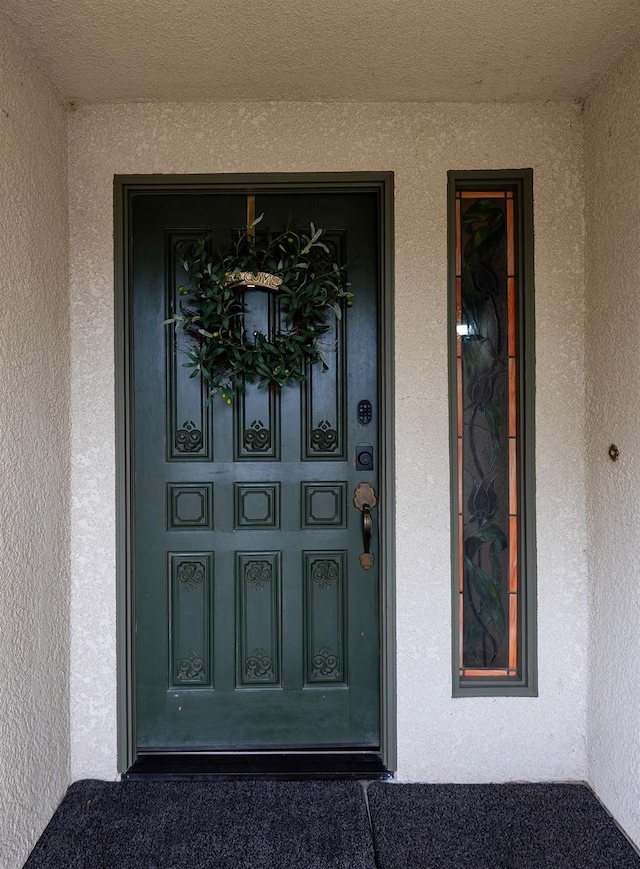 property entrance featuring stucco siding