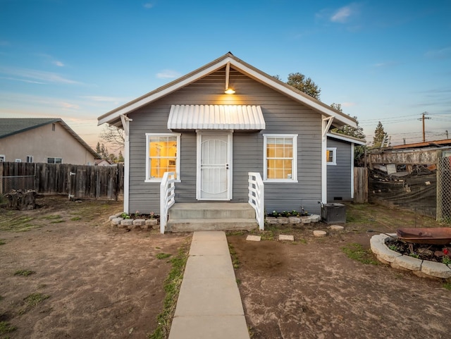 bungalow-style house with fence