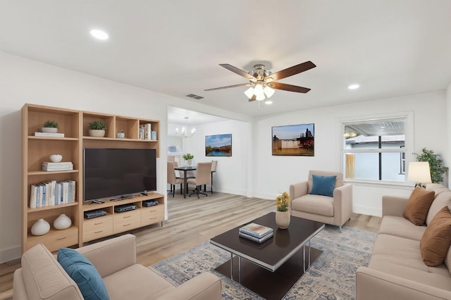 living room with light wood-style floors, recessed lighting, and visible vents