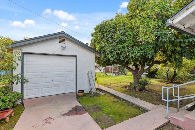 detached garage with concrete driveway