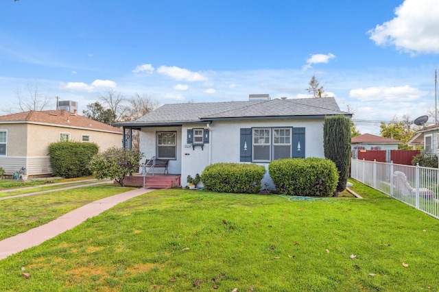 bungalow-style home featuring covered porch, a front yard, fence, and stucco siding