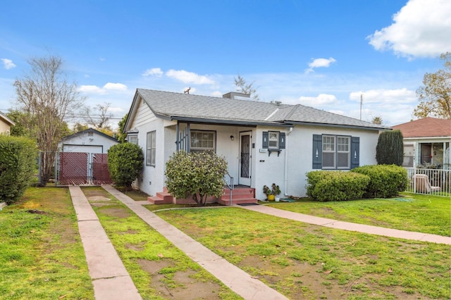 bungalow-style home with a shingled roof, fence, a gate, stucco siding, and a front yard