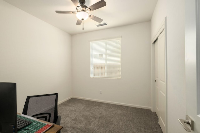 unfurnished office featuring ceiling fan, carpet, visible vents, and baseboards