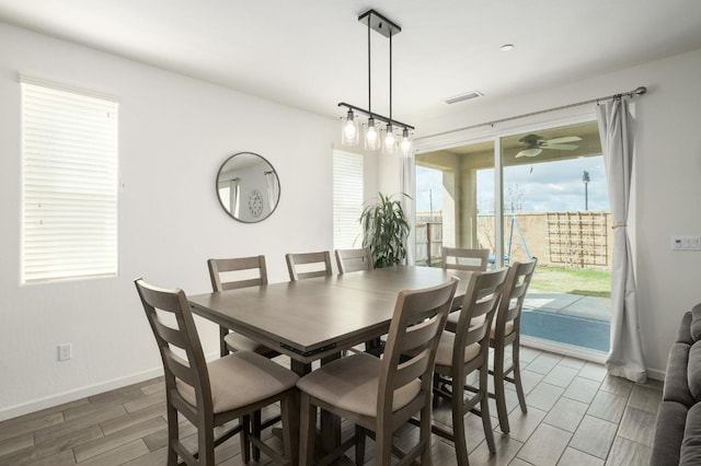 dining room with ceiling fan, wood finish floors, visible vents, and baseboards