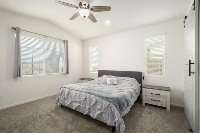 carpeted bedroom with lofted ceiling, ceiling fan, baseboards, and a barn door