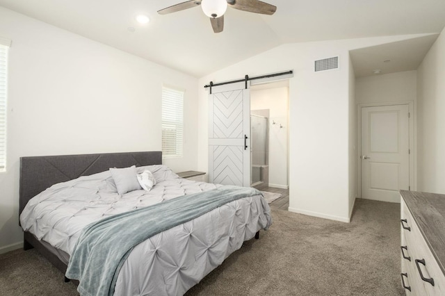 bedroom with a barn door, baseboards, visible vents, lofted ceiling, and carpet flooring