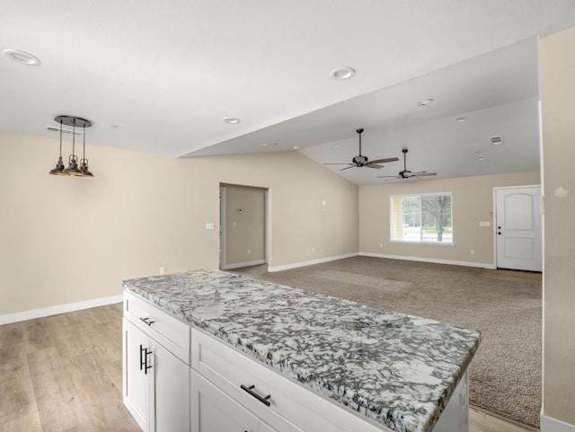 40023 Woodsong Way, Oakhurst, CA 93644 - kitchen featuring lofted ceiling, baseboards, white cabinetry, and hanging light fixtures