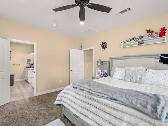 40023 Woodsong Way, Oakhurst, CA 93644 - bedroom featuring light colored carpet, visible vents, baseboards, and ensuite bathroom